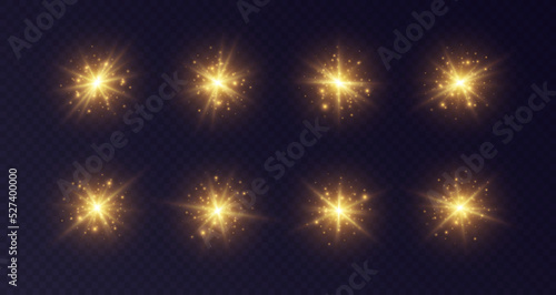Shining sun flares with stars and sparkles. Golden lens flare, stardust, shining star with rays concept. Glowing vector light effect isolated on a dark transparent background.