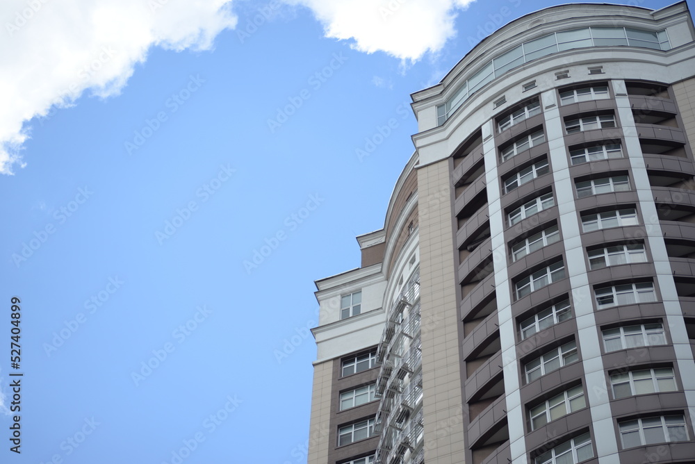 modern buildings against the background of a cloudy sky, a green new building a large number of windows, entire buildings in Ukraine, the top angle of the photo