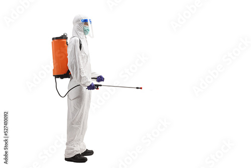Man in a hazmat suit carrying a disinfectant bottle on his back photo