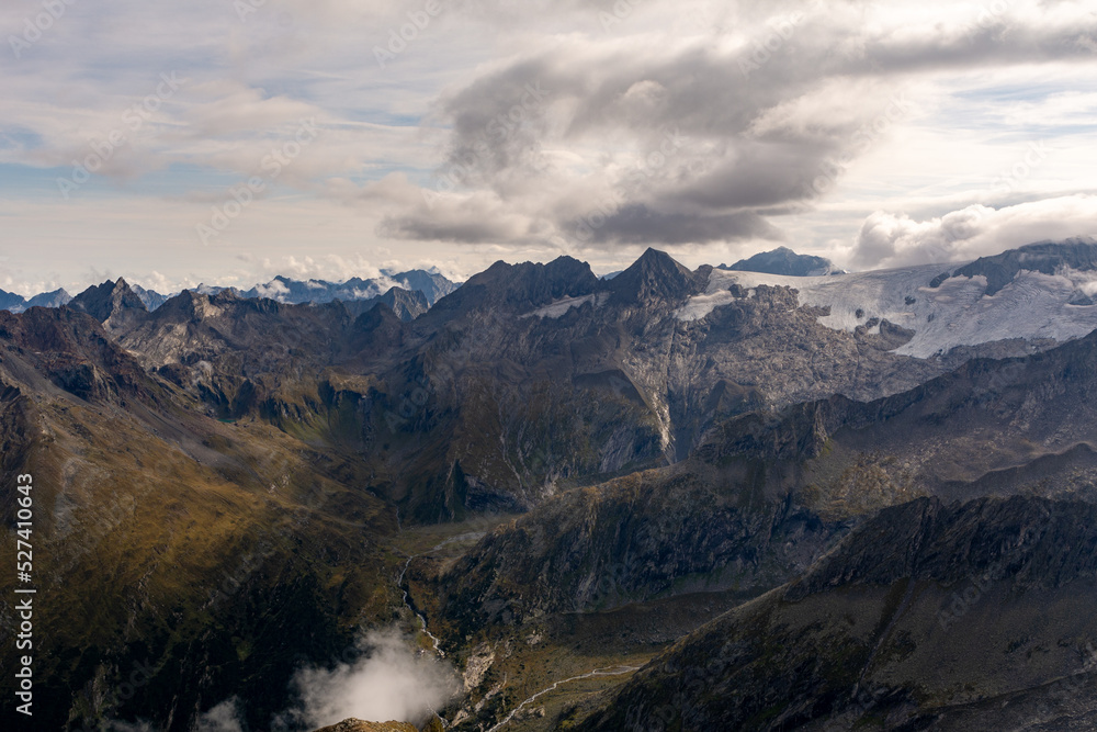 Fototapeta premium Alpine mountain peaks covered in clouds