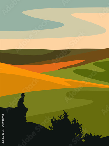Silhouette of a man against the backdrop of an autumn landscape with fields.