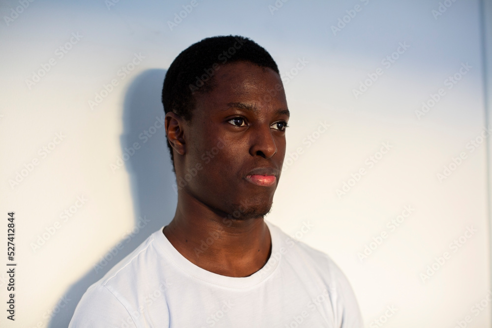 Teenage boy contemplating against white wall Teenage boy contemplating against white wall