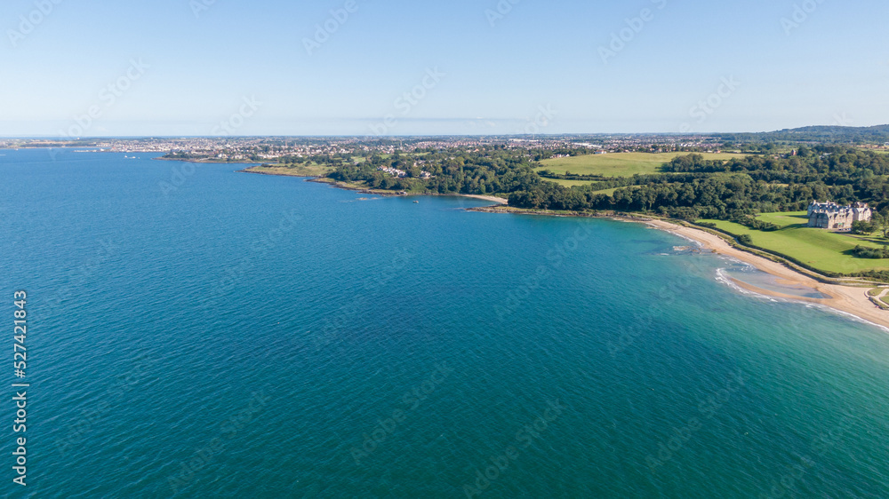 Aerial view on beach and coast of see in Helen's Bay, Northern Ireland. Drone shot sunny day 
