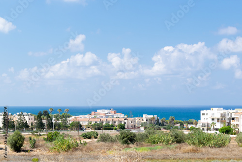 Cyprus landscape. View of the city. Limestone buildings by the sea. Sea and mountains.