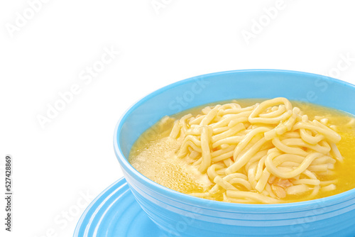 Chicken noodle soup in blue bowl with copy space