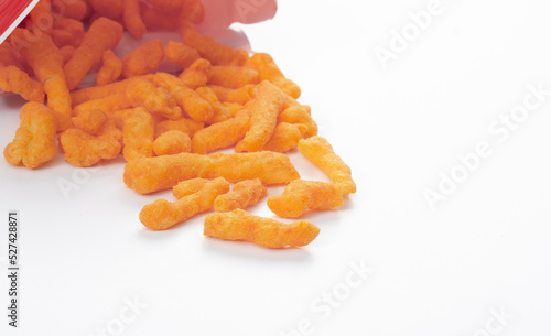 Zesty cheese crunchers spilling out of chip bag with copy space photo