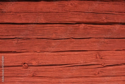 Close up of a wooden cottage with deep Falu red or falun red paint.  photo