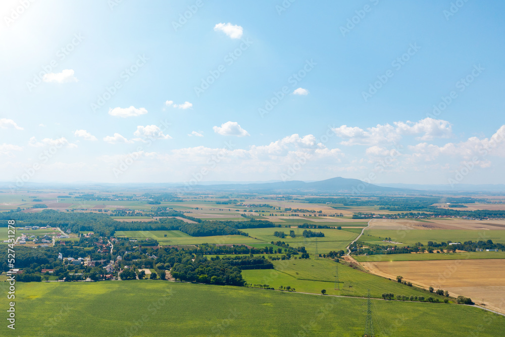 Rural landscape, green fields and small mountains in the background Rural landscape, green fields and small mountains in the background