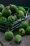 feijoa fruits in a supermarket basket on dark background