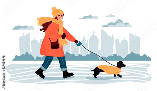Young woman walks a dachshund dog in a city park.Characters in warm clothes.The concept of outdoor walks with her beloved pet in cold season.Background with city silhouette .Vector flat illustration.