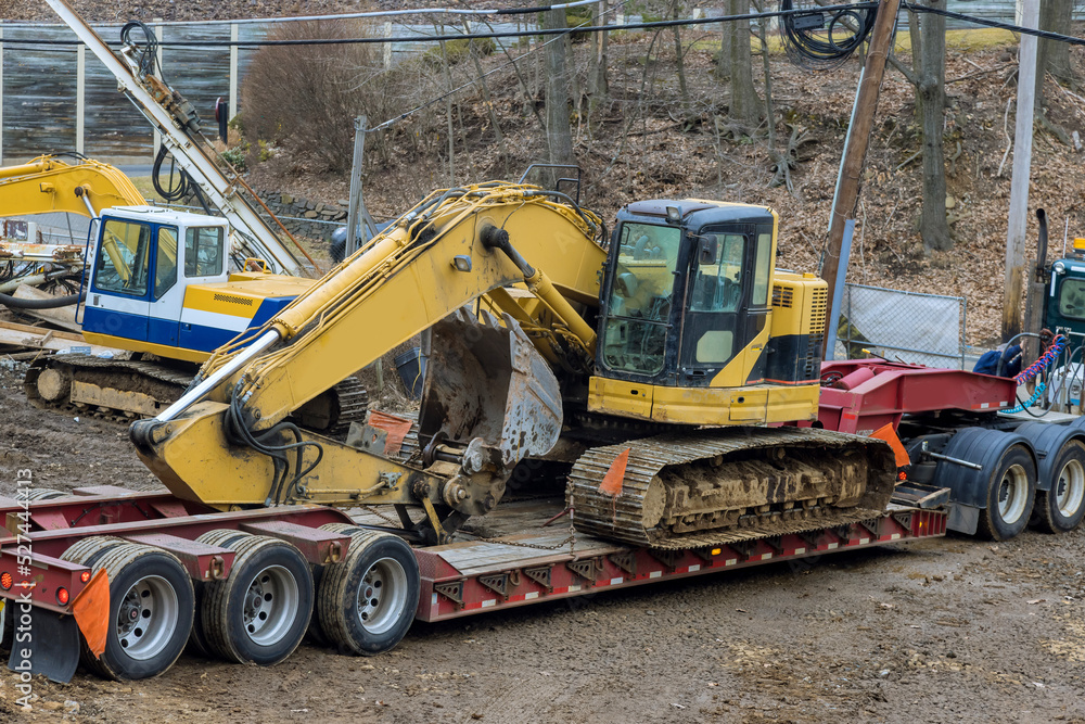 Using trailer platform to carry heavy construction equipment is a dangerous task Using trailer platform to carry heavy construction equipment is a dangerous task