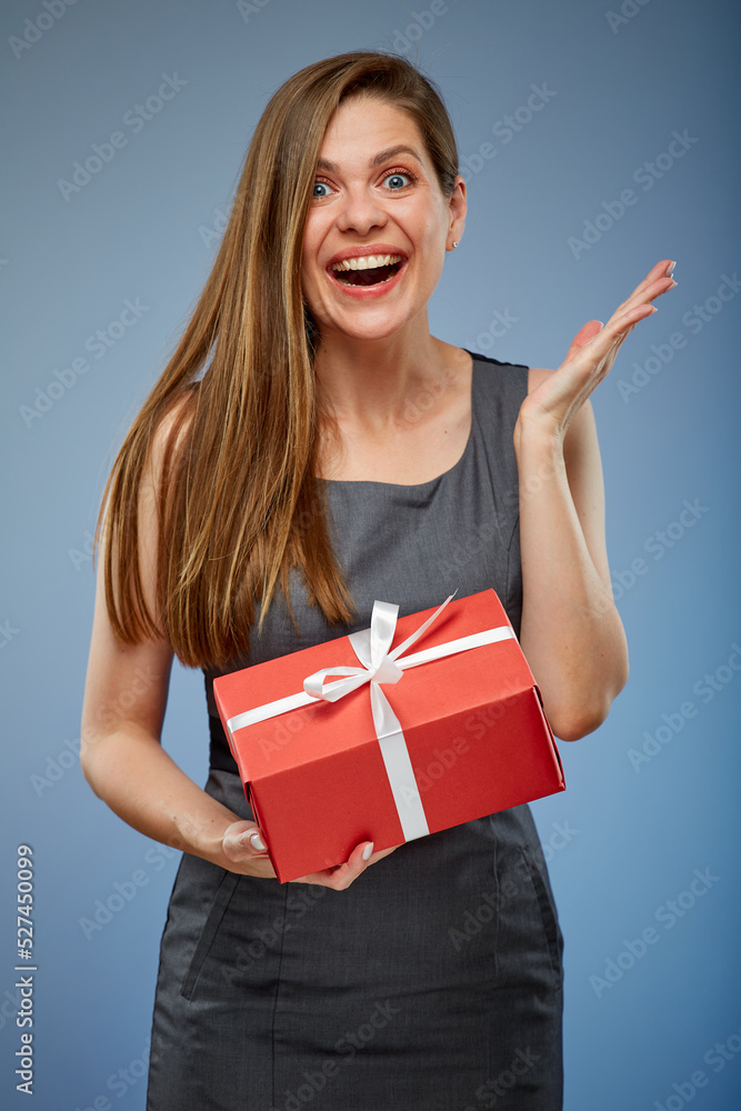 Surprising woman with red gift box studio isolated portrait on blue. Surprising woman with red gift box studio isolated portrait on blue.