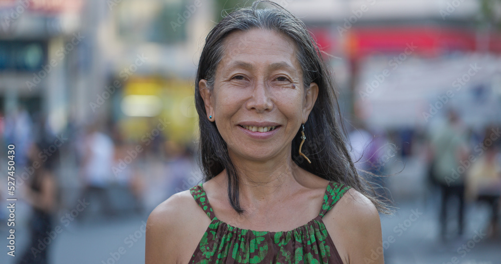 Mature Asian woman smile happy face portrait on city street