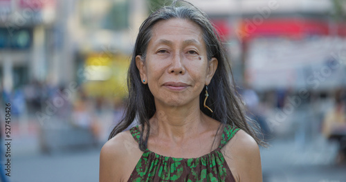 Mature Asian woman smile happy face portrait on city street