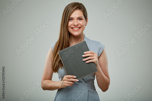 Smiling teacher or female businessperon with book. Isolated portrait.