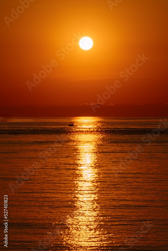 Meditation ocean and panoramic beach landscape. Orange and golden skylight calmness relaxing summer mood. Sunset sky reflecting in the water, aerial view. Travel destinations, vacations concept. ..