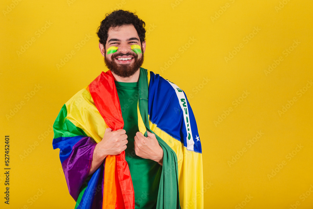caucasian man with beard, brazilian, soccer fan from brazil, wearing lgbt flag,.concept of