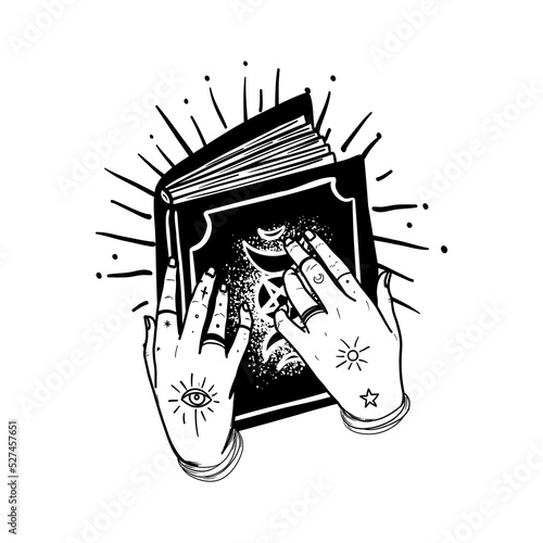 Human hands with tattoo holding magic book. Astrology, witchcraft, book of sp...