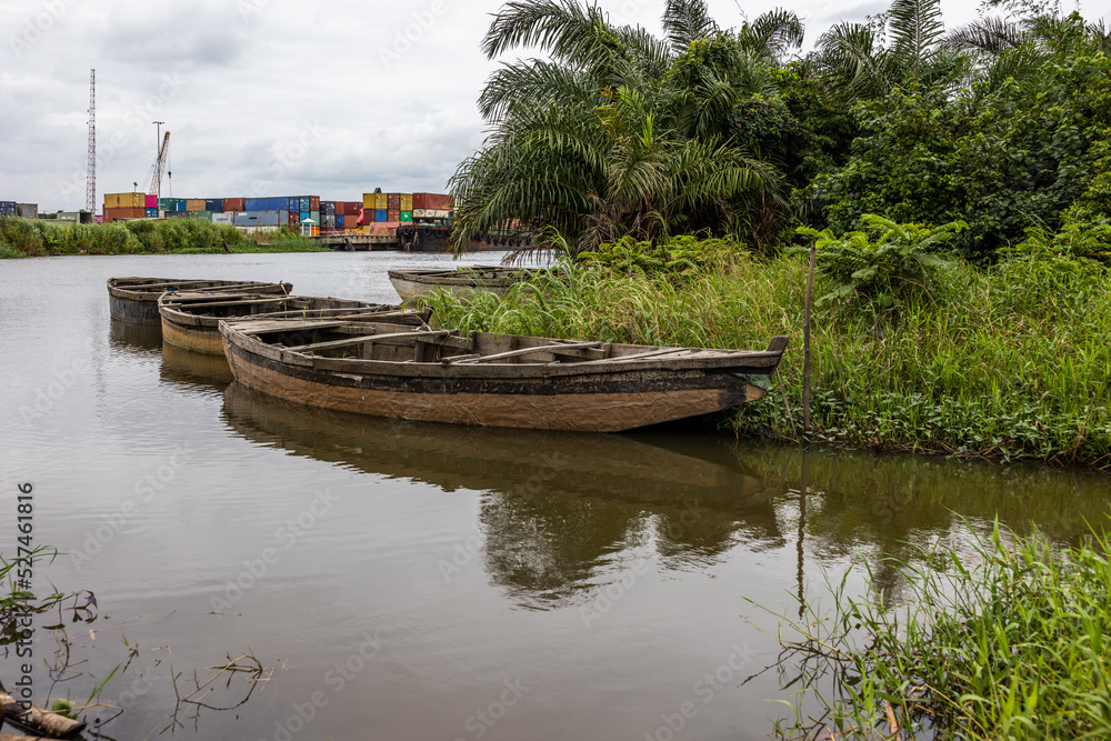 Fototapeta premium Boats and the bank of Aye river at Itokin in South west of Nigeria. Also known as river Itaw