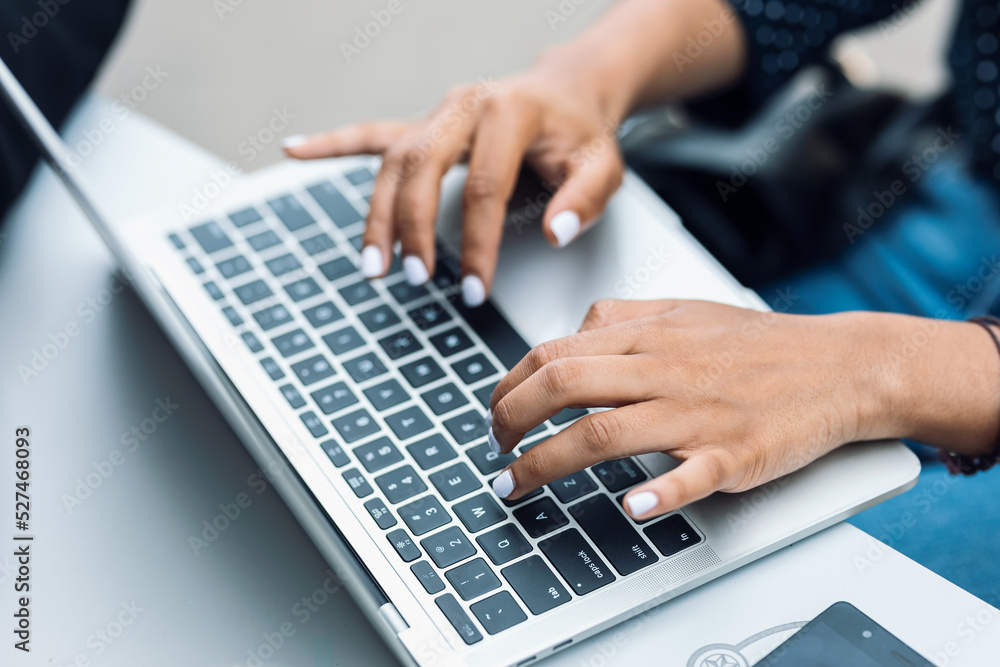 Business woman hands working with her laptop on a bar terrace Business woman hands working with her laptop on a bar terrace