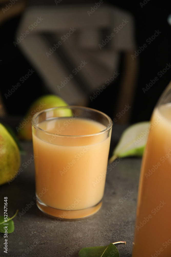 Fresh pear juice in glass on grey table Fresh pear juice in glass on grey table