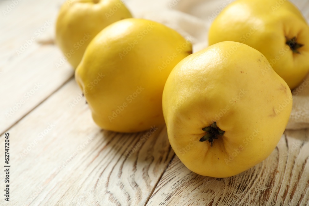 Fresh ripe organic quinces on white wooden table, closeup Fresh ripe organic quinces on white wooden table, closeup