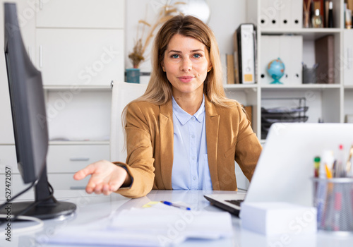 positive woman working on her laptop in white room
