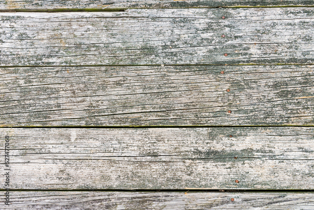 background from old wooden boards with nails. The impact of the atmosphere and precipitation. background from old wooden boards with nails. The impact of the atmosphere and precipitation.