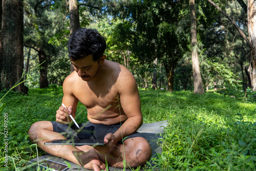 young man athletic body, drawing the chakaras, while explaining them in class online, mexico latin america