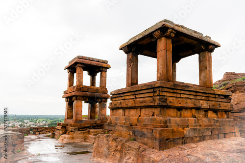 The remnants of pavilions(Open Mandapas) at Badami, perhaps once part of a Chalukya palace, are balanced on cliffs with temples in the distance, Karnataka,India photo