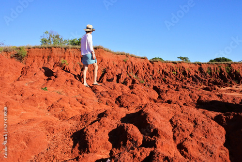 Australian woman hiking on red cliff in Cape Leveque Western Australia