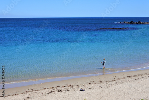 Australian man fishing on a remote beach © Rafael Ben-Ari