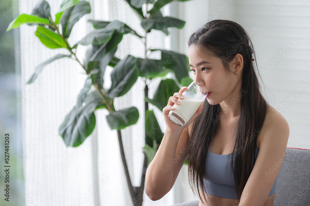 young beautiful woman person are drinking a fresh milk for body health care, smile girl holding glass of milk by happy attractive lifestyle at home, dairy breakfast product having calcium young beautiful woman person are drinking a fresh milk for body health care, smile girl holding glass of milk by happy attractive lifestyle at home, dairy breakfast product having calcium