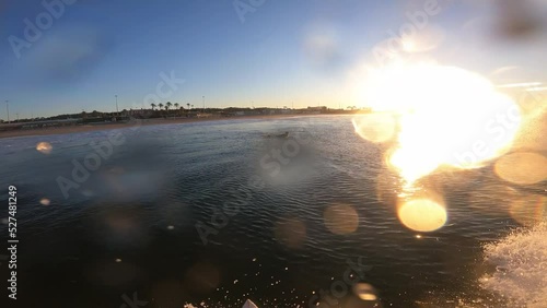 Surfer breaking waves on a Carcavelos surf spot in Lisbon during amazing sunrise.