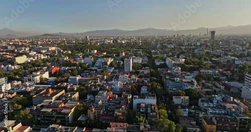 Mexico City Aerial v12 cinematic dolly in shot, drone flying south across roma norte neighborhod capturing populous urban cityscape at sunset - Shot with Mavic 3 Cine - December 2021 photo