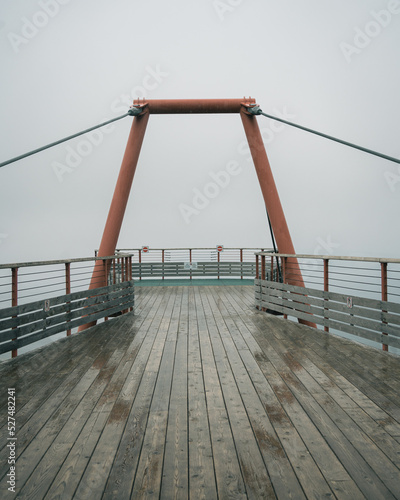 Fototapeta Modern observation deck on a rainy day, Percé, Quebec, Canada