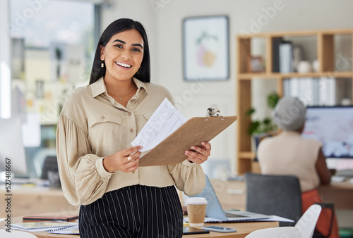 Review, contract and report with a business woman holding a clipboard with paperwork in her office at work. Application, document and proposal with a young female employee reading notes and working