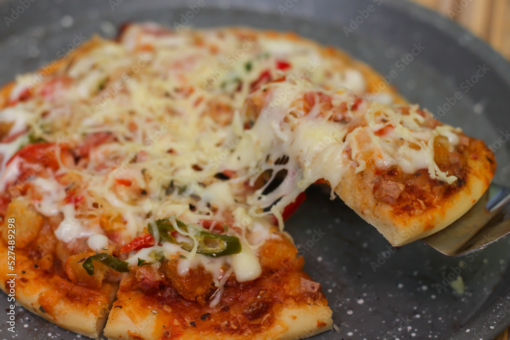 Delicious home made pizza with extra cheese. Delicious home made pizza with extra cheese.