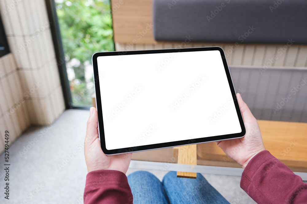 Mockup image of a woman holding digital tablet with blank white desktop screen Mockup image of a woman holding digital tablet with blank white desktop screen