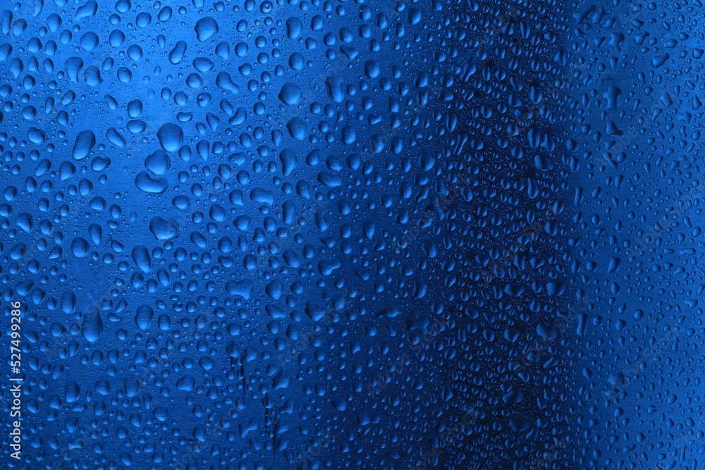 Obraz premium Abstract water droplets on metal surface with blue color.