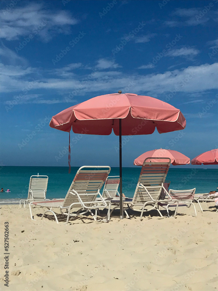 beach chairs and umbrella in grace bay turks and caicos