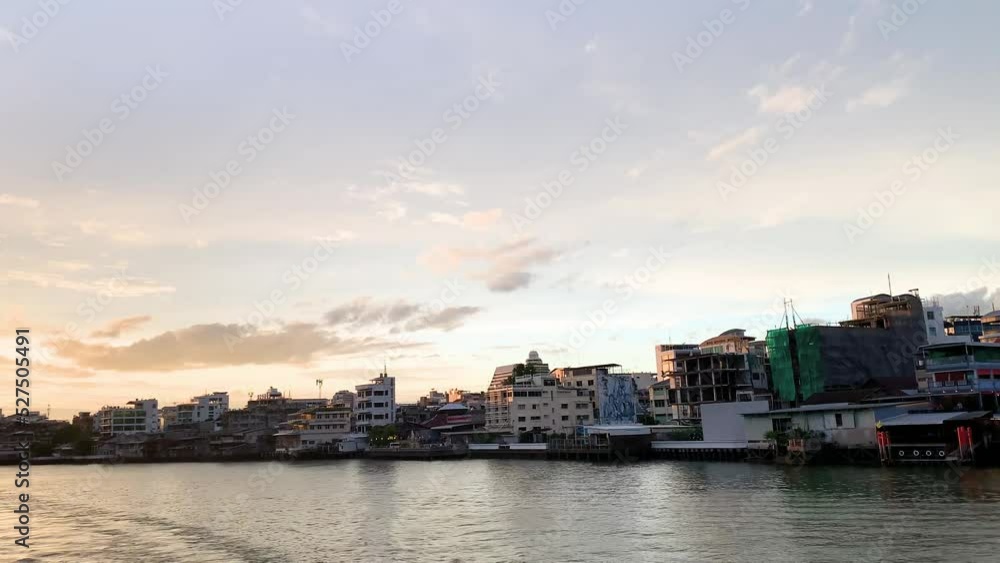 Sunset evening with city scenery riverside view from cruise in Chao Phraya river, famous tourist trip in Bangkok Thailand Sunset evening with city scenery riverside view from cruise in Chao Phraya river, famous tourist trip in Bangkok Thailand