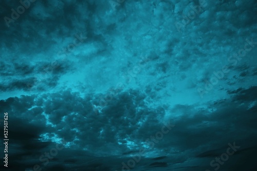 Black blue green night sky with clouds. Wind. Before the storm. Dramatic skies. Dark teal color background for design. Abstract. Toned cloudy gloomy sky. Dusk.