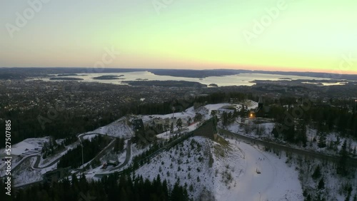 Oslo city drone push in, Vinterpark Winterpark Tryvann Past Ski Jump at Sunset Holmenkollen with nordic cross country skiing photo