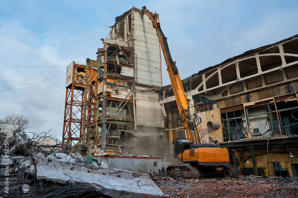 Destroying of old industrial building by excavator destroyer Destroying of old industrial building by excavator destroyer