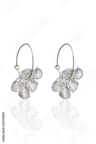 Close-up shot of hoop earrings with pearlescent flower. The french clip resin flower earrings are isolated on a white background. Side view.