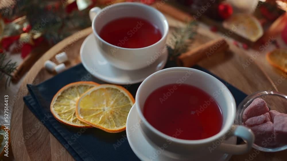 two cups of black or berry red hot english christmas tea with decor and candle two cups of black or berry red hot english christmas tea with decor and candle