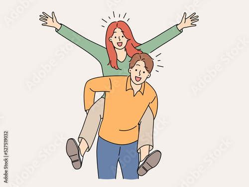 Happy woman piggyback smiling man 