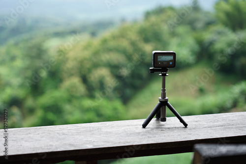 Closeup of action camera taking a timelapse on tripod. 
