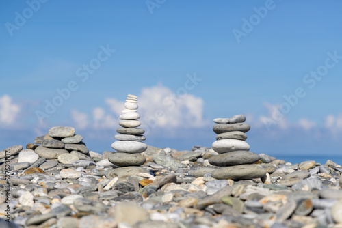 Pebble tower balance harmony stones arrangement on sea beach coastline photo